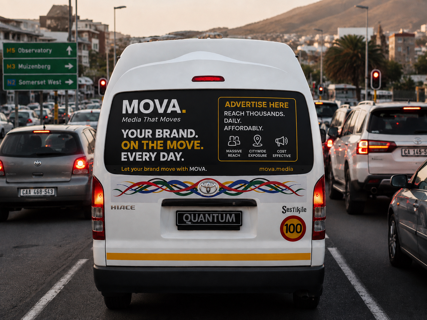 Rear view of a white Toyota Quantum minibus in South African traffic with MOVA rear-window branding